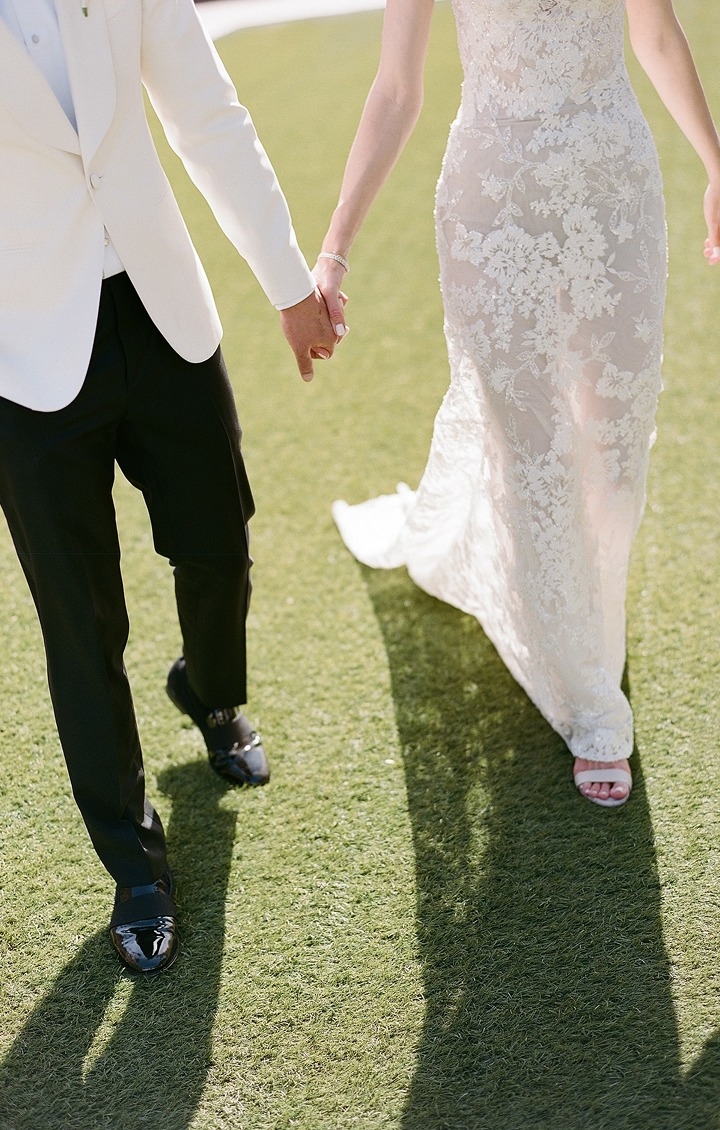 Photo of the couple walking on the grass