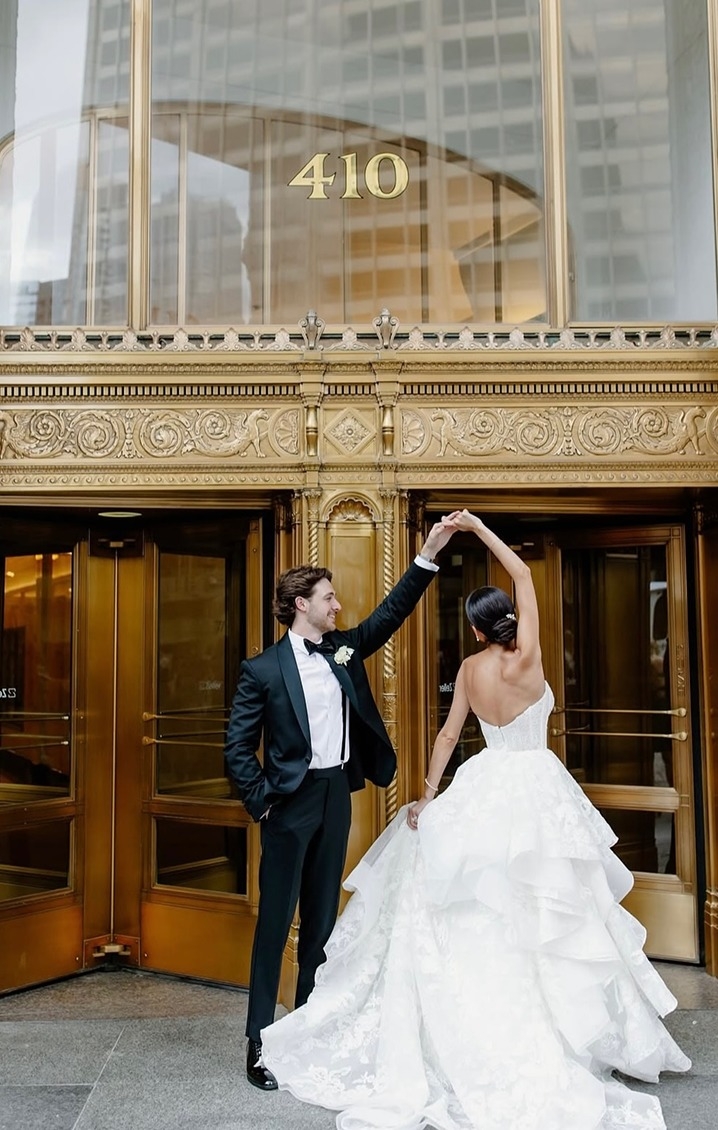 Photo of the couple dancing near the building